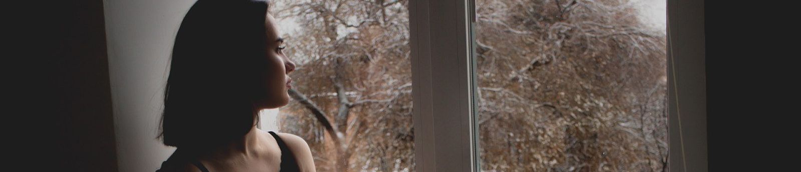 A young woman looking out the window.